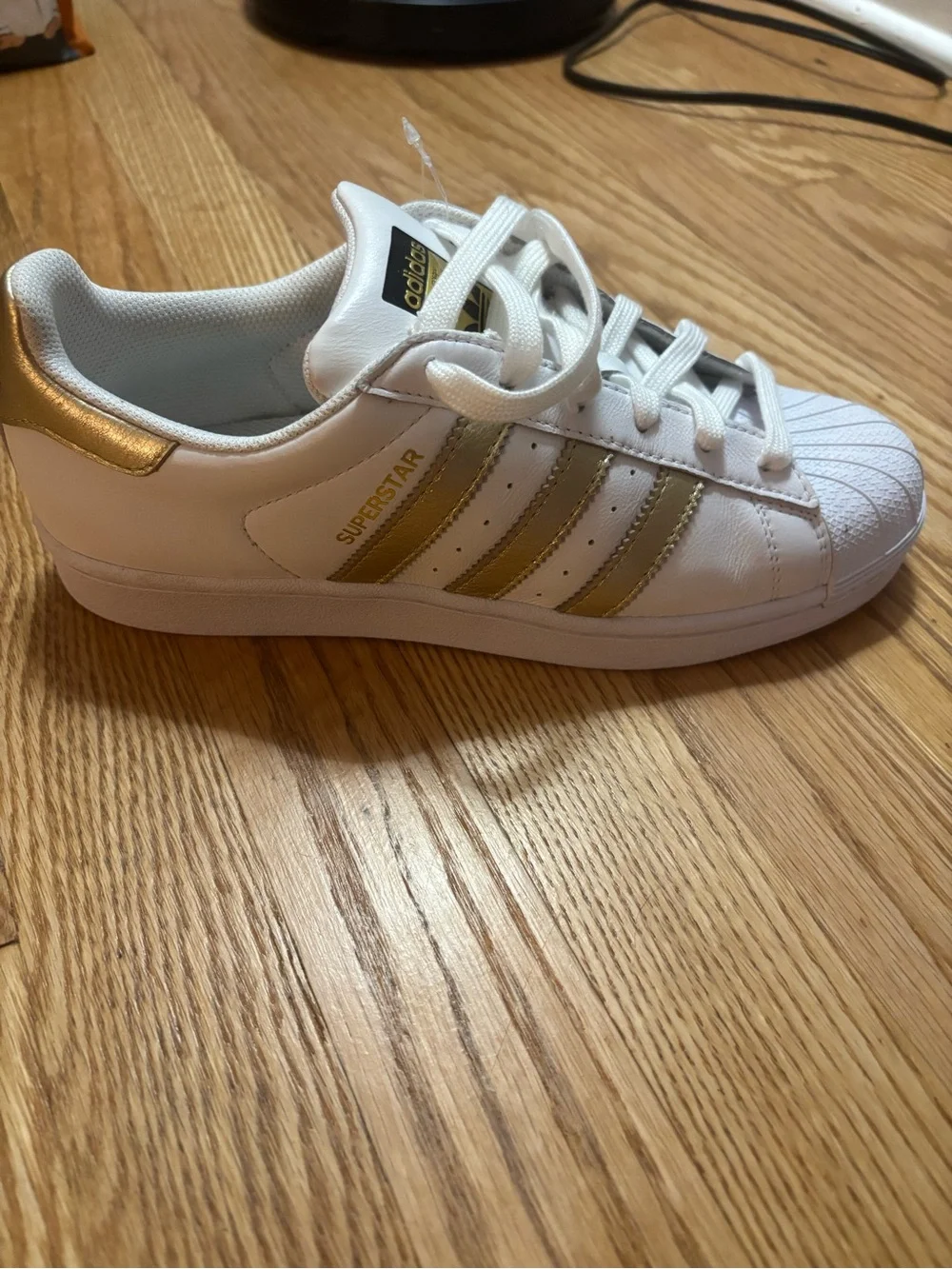 adidas Women's White Sneakers with Gold Stripe Accents